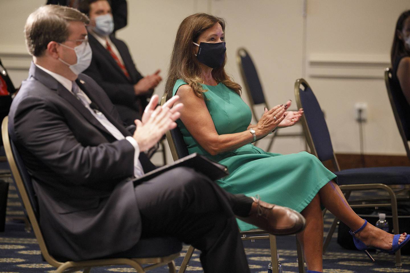 Secretary of Veterans Affairs Richard Wilkie, left, and second lady Karen Pence, wearing protective masks against COVID-19, applaud as they attend an event on a campaign to raise awareness on the risks of veterans suicide on July 7, 2020, at the National Press Club in Washington.