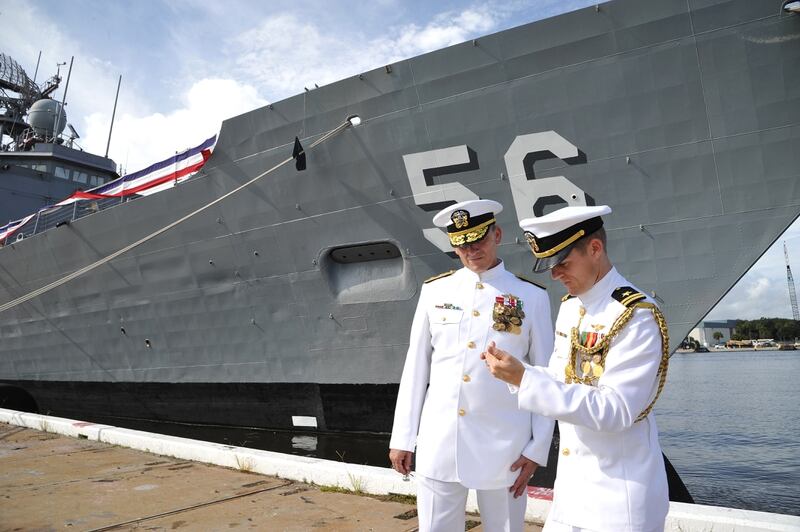 Rear Adm, Rick Williamson, left, commander of the Navy's Mid-Atlantic Region, had his assistant Lt. Josh Moore take his picture in front of the USS Simpson at Naval Station Mayport , Tuesday, Sept. 29, 2015, in Jacksonville, Fla. The USS Simpson, the last of the US Navy's Oliver Hazard Perry-class guided missile frigates, was is to be decommissioned. The ship has been is service since 1984. Williamson, a Jacksonville native, was the Simpson's commanding office in 2004. Moore is a graduate of the University of North Florida. (Bruce Lipsky/The Florida Times-Union via AP) MANDATORY CREDIT 
