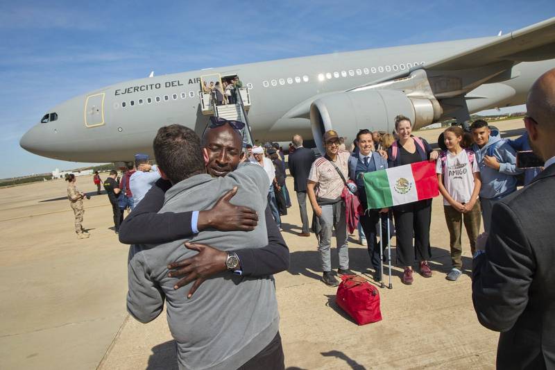 In this photo provided by the Spanish Defence Ministry passengers from Sudan disembark from a Spanish Air Force aircraft at Torrejon Air Base in Madrid, Monday April. 24, 2023.