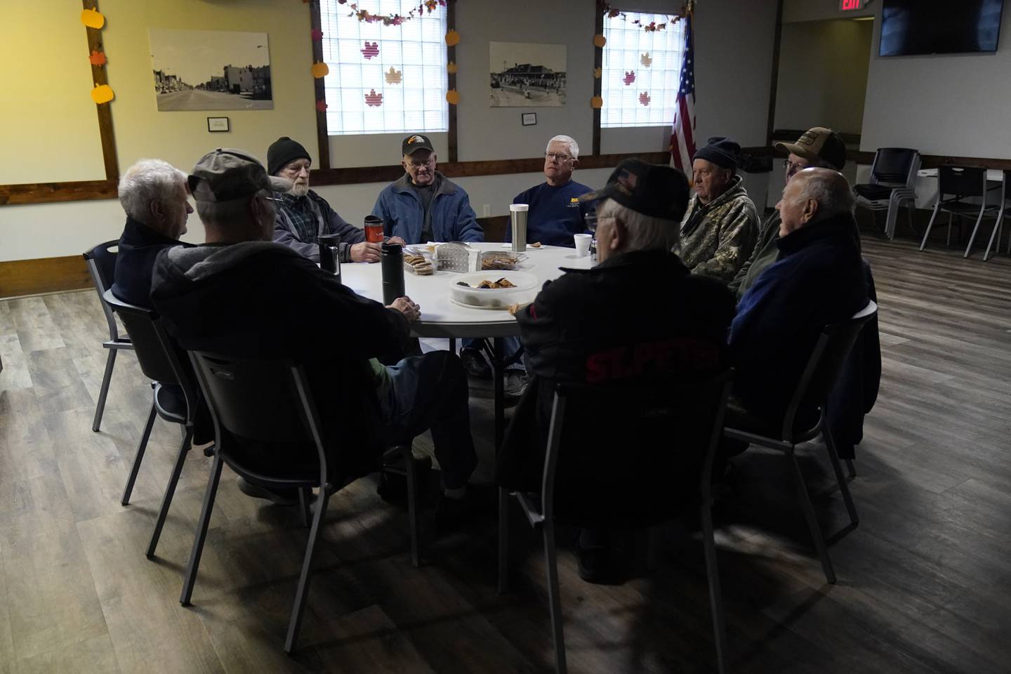 Earl Meyer, middle left, who fought for the U.S. Army in the Korean War, talks with fellow veterans at the American Legion, Tuesday, Nov. 7, 2023, in St. Peter, Minn.