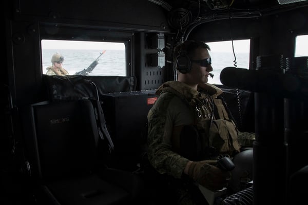 Electronics Technician 3rd Class Matthew Malay, from Worcester, Massachusetts, right mans the aft MK50 Stabilized Small Arms Mount on a Mark VI patrol boat. (Navy photo by MC2 Cat Olaes)