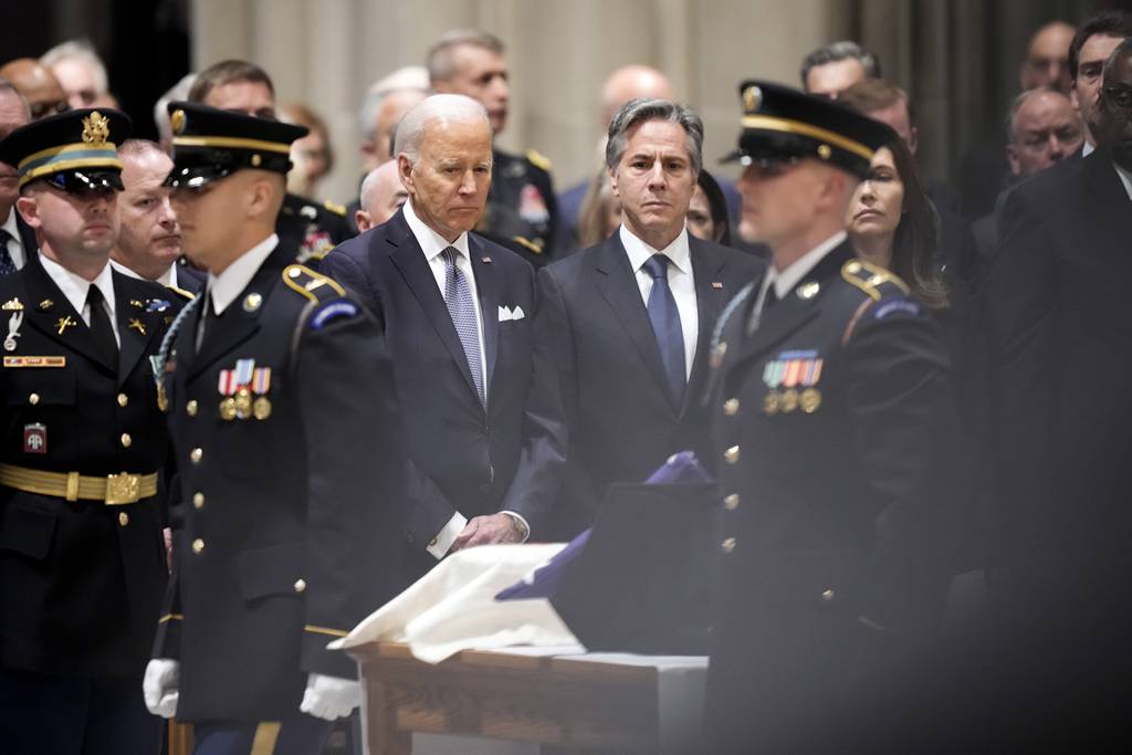 President Joe Biden and Secretary of State Antony Blinken look towards the urn with the cremated remains of former Defense Secretary Ash Carter during a memorial service for Carter at the National Cathedral, Thursday, Jan. 12, 2023, in Washington.