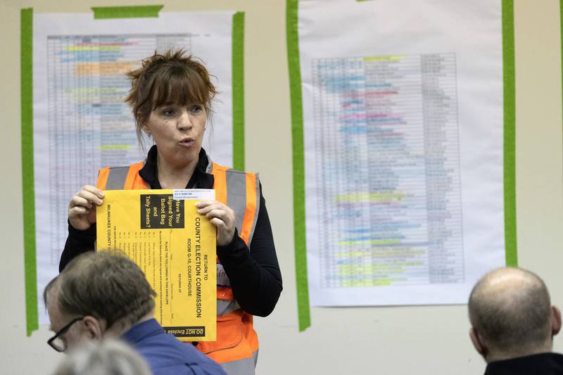 Kimberly Zapata, deputy director of the Milwaukee Election Commission, instructs workers processing ballots, Tuesday, April 5, 2022, at the central counting facility in Milwaukee, Wis.