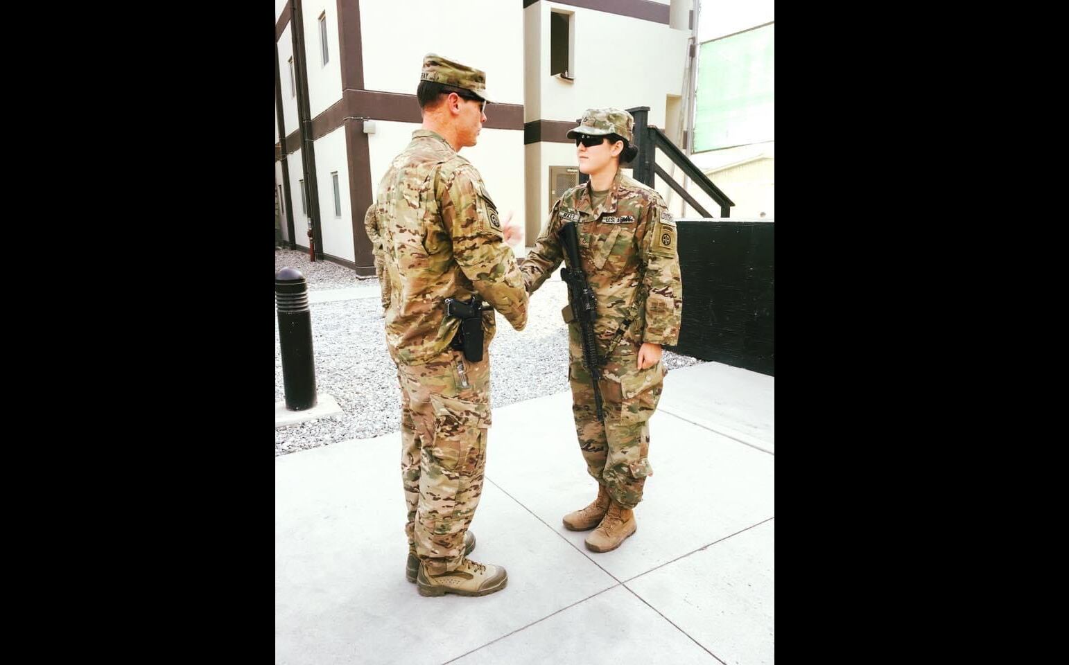 In this 2017 photo, then Command Sgt. Maj. Clinton Murray shakes hands with Morgan Masters after participating in her promotion ceremony near Kabul, Afghanistan. Murray was acquitted of sexually assaulting Masters during this deployment. (Courtesy of Morgan Masters)