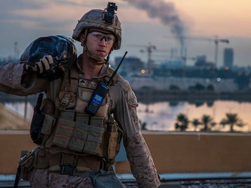 In this Jan. 4, 2020, photo, a U.S. Marine carries a sand bag during the reinforcement of the U.S. embassy compound in Baghdad, Iraq. (Sgt. Kyle C. Talbot/Marine Corps via AP)