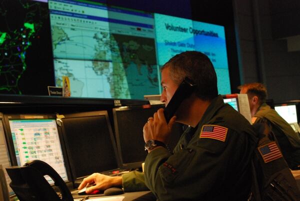 Lt. Col. Nicholus Costanzo, a Theater Direct Delivery Planner on the 618th Tanker Airlift Control Center's operations floor, coordinates a C-17 Globemaster III mission scheduled to deliver supplies to troops in Afghanistan in 2009.The 618th TACC is 18th Air Force’s 24-hour Air and Space Operations Center, located at Scott Air Force Base, Ill. (Capt. Justin Brockhoff/U.S. Air Force)