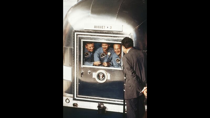 In this July 24, 1969, file photo, President Richard Nixon greets the Apollo 11 astronauts in a quarantine van on board the USS Hornet after splashdown and recovery in the Pacific Ocean. From left are Neil Armstrong, Michael Collins, and Edwin 