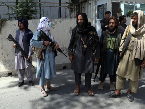 Taliban fighters stand guard at the main gate leading to the Afghan presidential palace in Kabul, Afghanistan, on Aug. 16, 2021. (Rahmat Gul/AP)