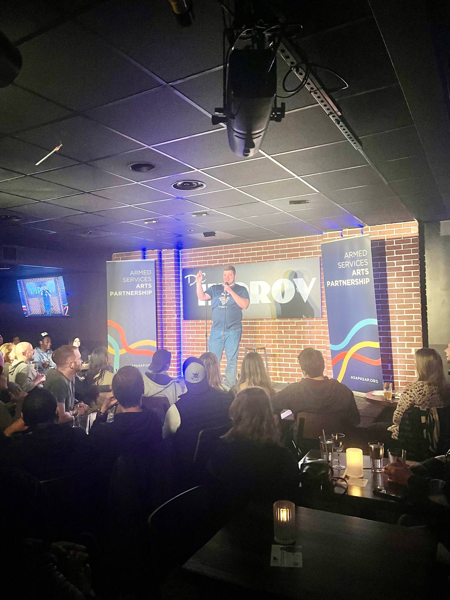 Navy Lt. Joey Deaven performs at the ASAP comedy bootcamp graduation showcase on May 3, 2023, at the DC Improv in Washington, D.C.