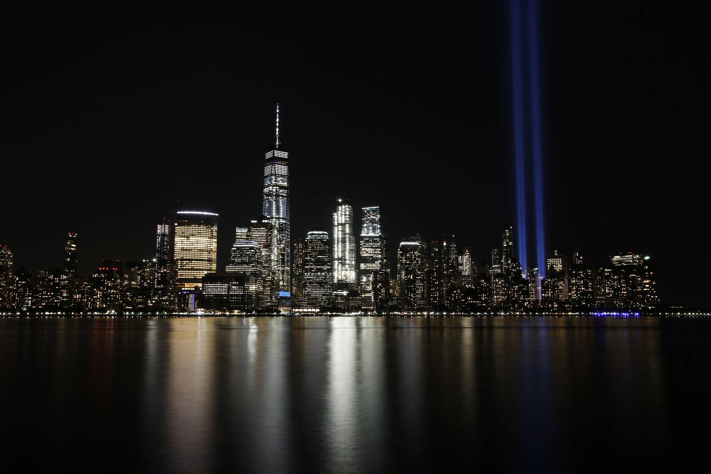In this Sept. 11, 2017, file photo, the Tribute in Light illuminates in the sky above the Lower Manhattan area of New York, as seen from across the Hudson River in Jersey City, N.J.