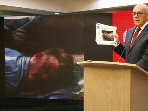 In this photo released by the Venezuelan officials, Communications Minister Jorge Rodriguez shows a photograph of a man he identifies as former U.S. special forces soldier Luke Denman and taken in Venezuela during his arrest, in Caracas, Venezuela, Tuesday, May 5, 2020. (Venezuelan Communications Ministry press office via AP)