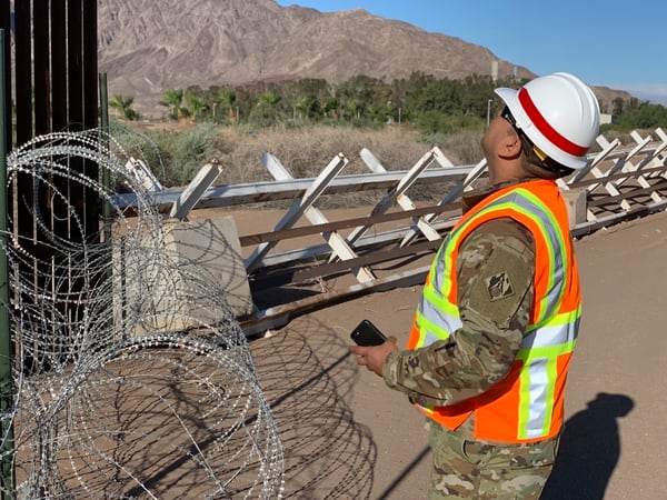 An Army Corps of Engineers soldier inspects existing a vehicle barrier and border fence near El Centro, CA, on May 7. (San Luciano Vera/Army)