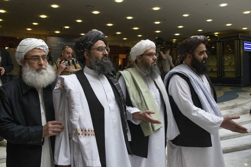 Mullah Abdul Ghani Baradar, the Taliban group's top political leader, second from left, arrives with other members of the Taliban delegation for talks in Moscow.