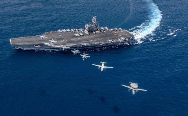 Multiple aircraft from Carrier Air Wing 5 fly in formation over the U.S. Navy’s aircraft carrier Ronald Reagan. (MC2 Kaila V. Peters/U.S. Navy)