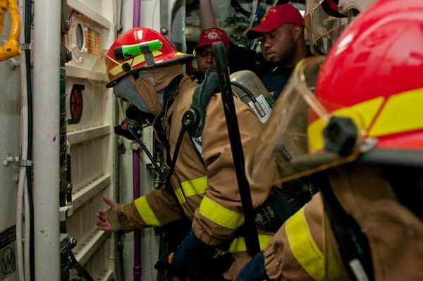 120818-N-NU634-016 ARABIAN SEA (Aug. 18, 2012) – Logistics Specialist Seaman Jorge Riveraroque checks a water tight door for heat before entering the space to battle a simulated fire during a damage control drill aboard the guided-missile cruiser USS Hue City (CG 66). Hue City is deployed to the U.S. 5th Fleet area of responsibility conducting maritime security operations, theater security cooperation efforts and support missions as part of Operation Enduring Freedom. (U.S. Navy photo by Mass Communication Specialist Seaman Darien G. Kenney/Released)