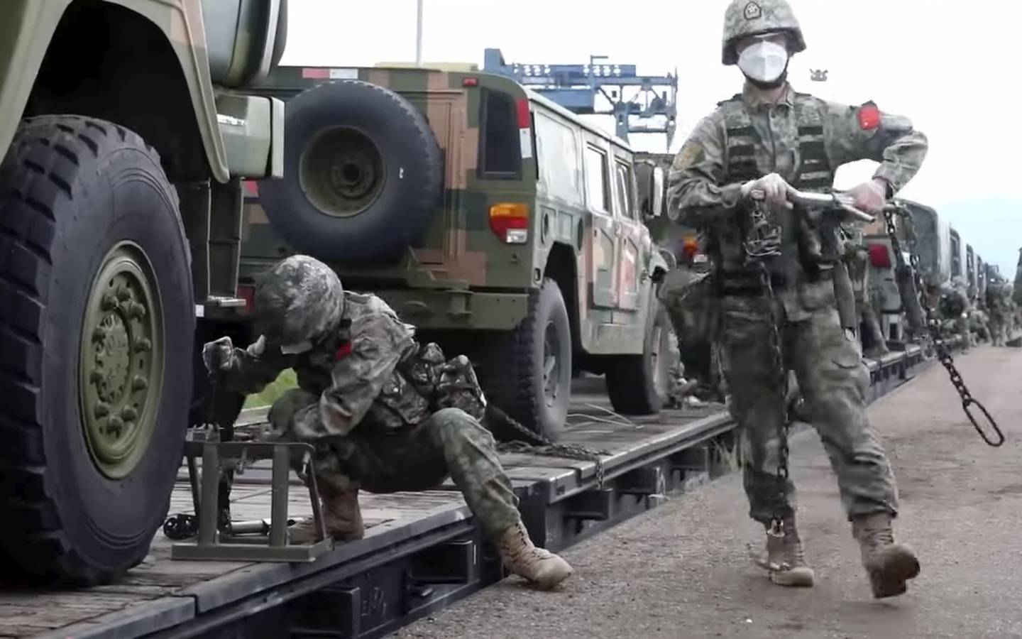 In this handout photo taken from video released by Russian Defense Ministry Press Service on Monday, Aug. 29, 2022, Chinese soldiers arrive to the Grodekovo railway station to participate in war games drills, in Grodekovo, Primorsky Krai, Russia.
