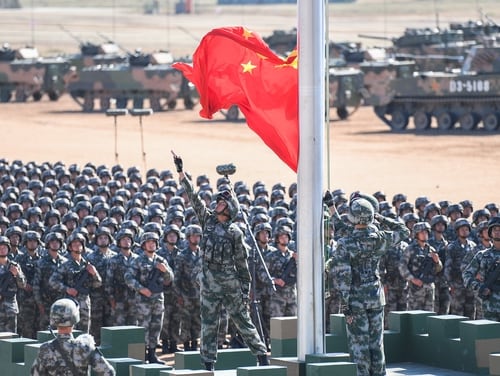 The Chinese flag is raised during a military parade at the Zhurihe training base in China's northern Inner Mongolia region on July 30, 2017. (AFP/Getty Images)