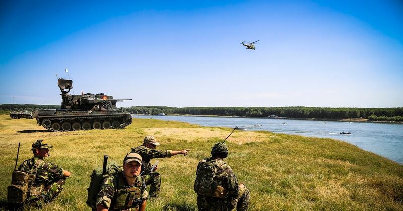 Romanian joint terminal attack control soldiers coordinate fixed-wing and rotor-wing assets for a river crossing exercise with multinational forces. The future of multi-domain operations will require U.S. forces to share intelligence and capabilities with allies. (Staff Sgt. Timothy Villareal/Army)
