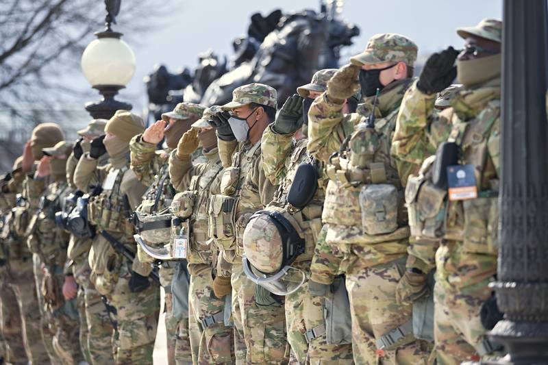 U.S. soldiers and airmen of the National Guard salute the presentation of the colors during the inauguration ceremony on Jan. 20, 2021, in Washington.