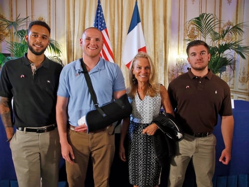 Anthony Sadler, a senior at Sacramento University in California, left, U.S. National Guardsman from Roseburg, Oregon, Alek Skarlatos, right, and U.S. Airman Spencer Stone, second from left, pose for photographers with Jane D. Hartley, U.S. Ambassador to France, before a press conference held at the U.S. Ambassador's residence in Paris, France, Sunday, Aug. 23, 2015. Sadler, Skarlatos and Stone helped foil a potentially deadly attack when they subdued a man armed with an assault rifle and other weapons on board a high-speed train bound for Paris two days ago. The man was known to intelligence services in three countries and had ties to radical Islam, authorities said Sunday. (AP Photo/Francois Mori)