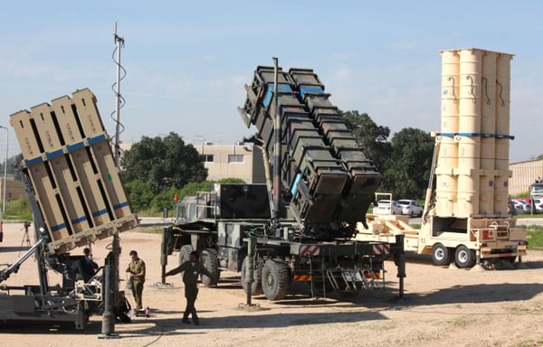 Israeli soldiers walk near an Israeli Irone Dome defence system (L), a surface-to-air missile (SAM) system, the MIM-104 Patriot (C), and an anti-ballistic missile the Arrow 3 (R) during Juniper Cobra's joint exercise press briefing at Hatzor Israeli Air Force Base in central Israel, on February 25, 2016. Juniper Cobra, is held every two years where Israel and the United States train their militaries together to prepare against possible ballistic missile attacks, as well as allowing the armies to learn to better work together. / AFP / GIL COHEN-MAGEN (Photo credit should read GIL COHEN-MAGEN/AFP/Getty Images)