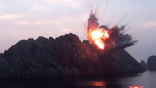 This Aug. 6, 2019, photo provided by the North Korean government shows what it says is a new type of tactical guided missile launched from an airfield in the western area of North Korea landing in an islet in waters off the country's eastern coast. (Korean Central News Agency/Korea News Service via AP)