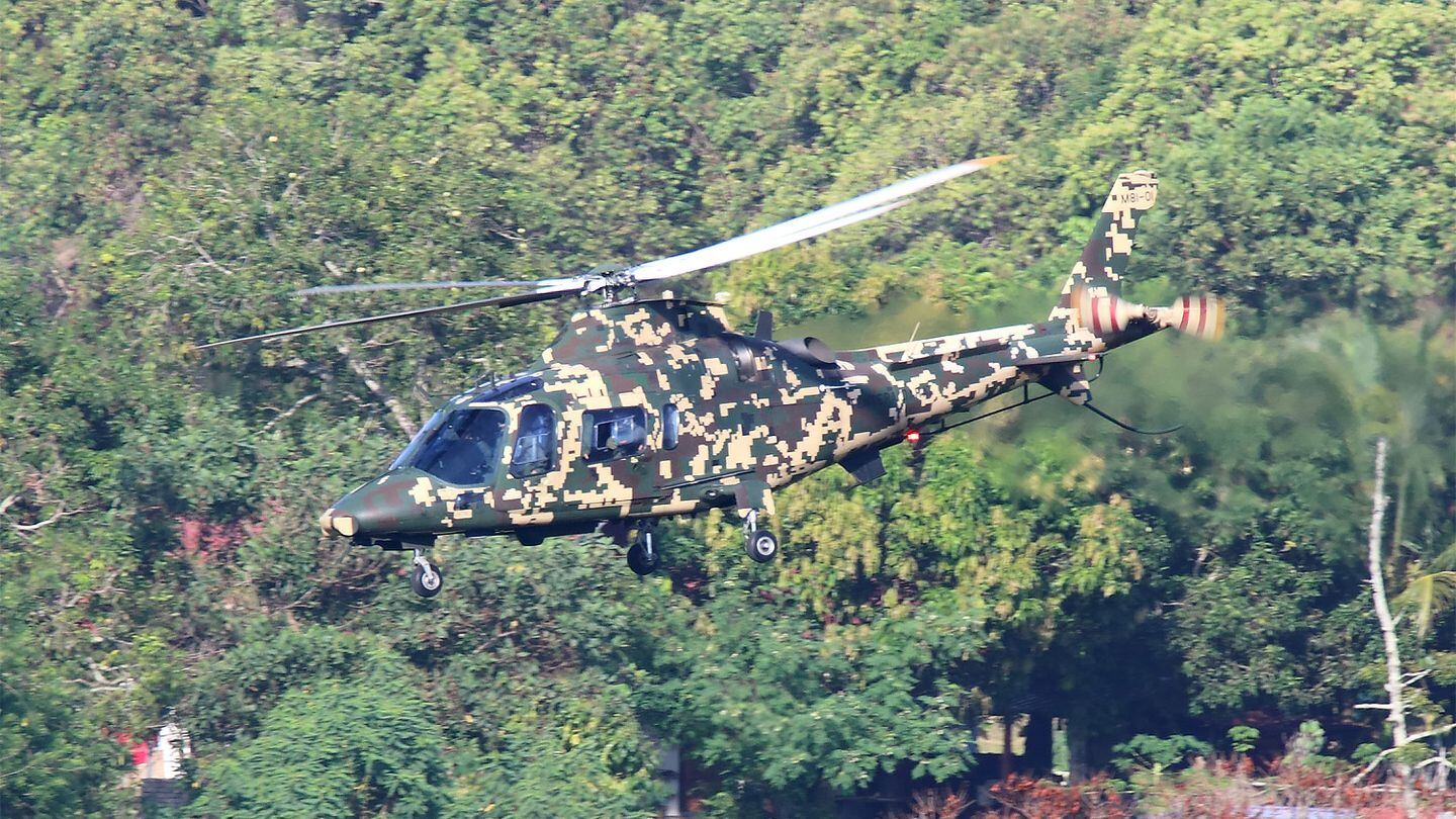 A Leonardo-made AW109 utility helicopter of the Malaysian Army flies against a jungle backdrop while taking off for its display. (Mike Yeo/Staff)