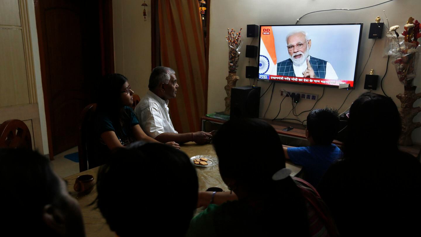 A family watches Indian Prime Minister Narendra Modi address the nation on March 27, 2019. The government had successfully tested an anti-satellite weapon. (Rajesh Kumar Singh/AP)