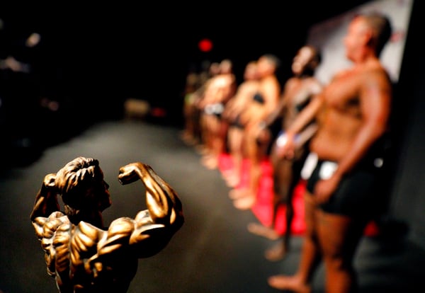 A trophy sits on display as contestants line up in front of the crowd at the International Association of Trans Bodybuilders competition in Atlanta on Saturday. (David Goldman/AP)