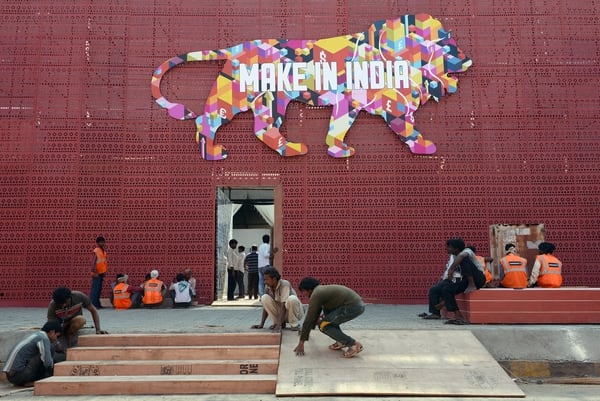 Indian workers set up the venue for the 