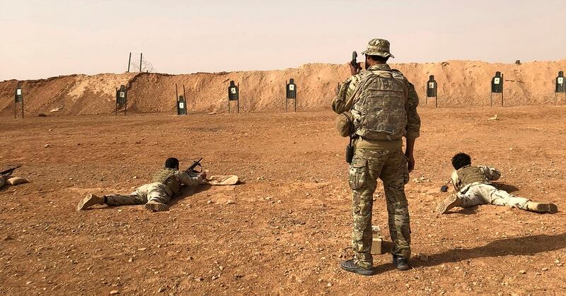 Members of the Maghawir al-Thawra Syrian opposition group receive firearms training from U.S. Army Special Forces soldiers at the Al Tanf military outpost in southern Syria on Monday, Oct. 22, 2018. (Lolita Baldor/AP)