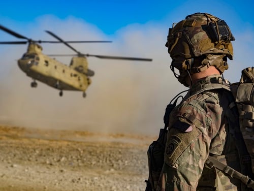 A U.S. soldier watches as a CH-47 Chinook helicopter prepares to land in preparation for the extraction of Afghan and U.S. soldiers following a key leader engagement Dec. 29, 2019, in southeastern Afghanistan. (Master Sgt. Alejandro Licea/Army)