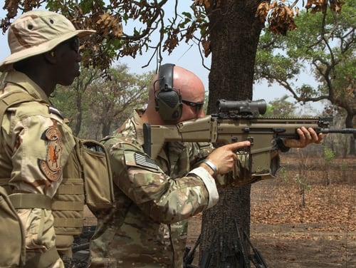 A U.S. Special Forces soldier demonstrates how to fire an Mk 17 sniper rifle for a Senegalese special forces soldier as part of interoperability training during Exercise Flintlock 2019, near Po, Burkina Faso, Feb. 21, 2019. (Sgt. 1st Class Mary S. Katzenberger/Army)