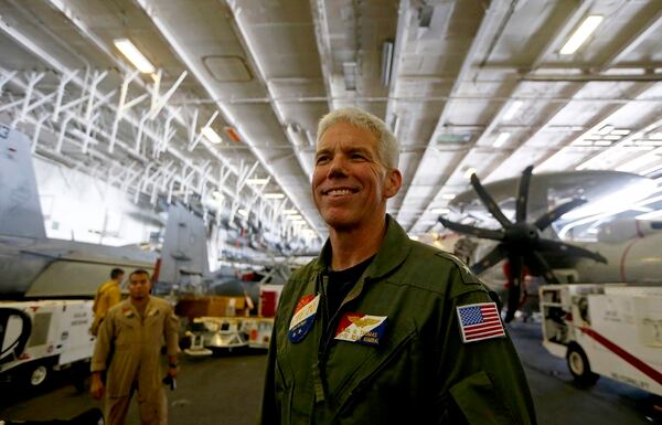 Rear Adm. Karl Thomas, Task Force 70/commander, Carrier Strike Group 5, poses before an E-2 Hawkeye plane following a media interview aboard the U.S. aircraft carrier USS Ronald Reagan off South China Sea on Aug. 6, 2019. (Bullit Marquez/AP)