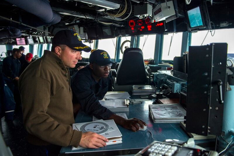 150515-N-UN259-089 EAST CHINA SEA (May 15, 2015) Cmdr. Jeffery Heames, commanding officer of the Arleigh Burke-class guided-missile destroyer USS Preble (DDG 88), discusses course corrections with Quartermaster Seaman Jeffrey Mensa. Preble is deployed to the 7th Fleet area of operations in support of security and stability in the Indo-Asia-Pacific region. (U.S. Navy photo by Mass Communication Specialist Seaman Alonzo M. Archer/Released)