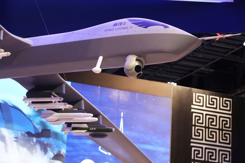 A model of a Wing Long II weaponized drone hangs above the stand for the China National Aero-Technology Import & Export Corp. at a military drone conference in Abu Dhabi, United Arab Emirates, Sunday, Feb. 25, 2018. (Jon Gambrell/AP)
