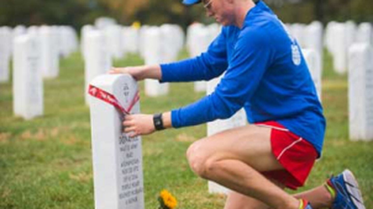 After running the Marine Corps Half Marathon alongside Wear Blue, Bailey’s brother, Seamus Donahue, leaves his medal at his father’s gravesite. Photo courtesy of the author.