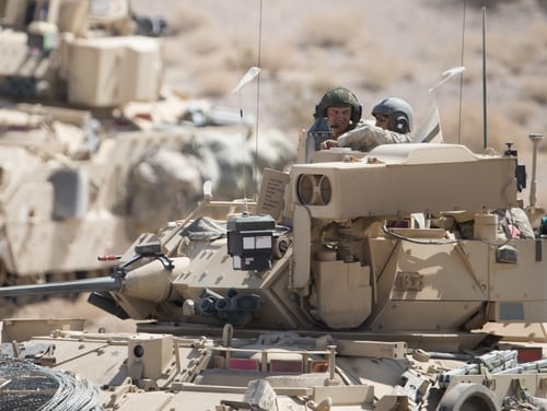 M2A3 Bradley Fighting Vehicle crew discuss an enemy target location while at the National Training Center, Fort Irwin, Calif., Aug. 25, 2015. (Maj. W. Chris Clyne/Army)