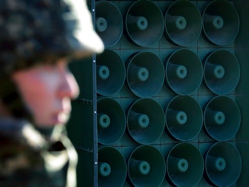 In this Jan. 8, 2016, file photo, a South Korean soldier stands near the loudspeakers near the border area between South Korea and North Korea in Yeoncheon, South Korea. South Korea says it has halted anti-Pyongyang propaganda broadcasts on the border ahead of the April 27, 2018, inter-Korean talks. (Lim Tae-hoon/Newsis via AP)