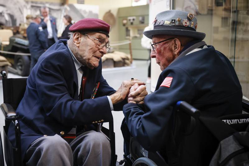 World War II veteran Britain's Bill Gladden, left, speaks with U.S WWII veteran Jack M. Larson in the Pegasus Bridge memorial in Benouville, Normandy, Monday June 5, 2023.