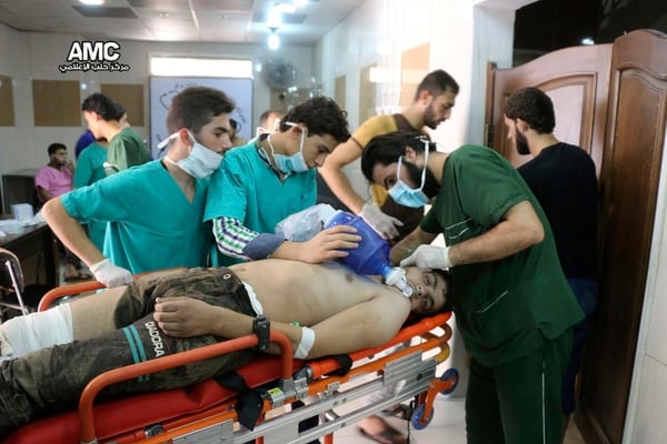 In this Sept. 6, 2016, file photo, provided by the Syrian anti-government activist group Aleppo Media Center (AMC), shows medical staff treating a man suffering from breathing difficulties inside a hospital in Aleppo, Syria, after a chemical attack. (Aleppo Media Center via AP)