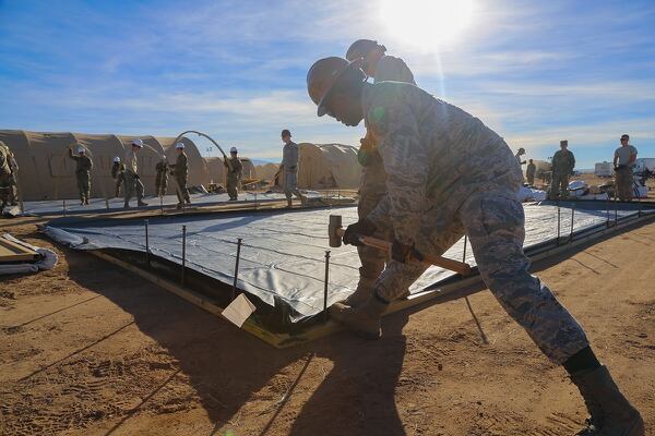 A U.S. airmen of 355 Civil Engineer Squadron secure the frame of a tent at Davis-Monthan Air Force Base, Ariz., Nov. 4, 2018. Various military branches are deployed as support to local Department of Homeland Security and U.S. Customs and Border Protection agents in support of Operation Faithful Patriot. (Spc. Keion Jackson/Army)