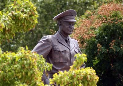 This Aug. 4, 2012, photo shows a large bronze statue of Gen. Dwight Eisenhower that stands over the grounds of his library, museum and boyhood home in Abilene, Kansas.