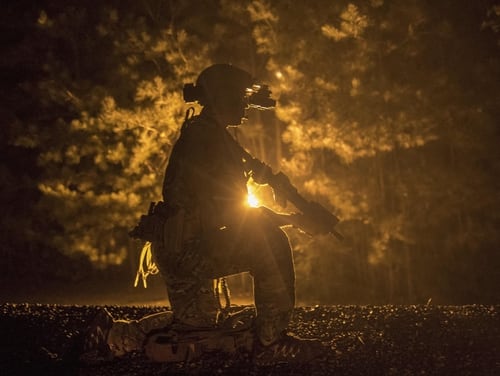 An Army Green Beret takes to one knee during a noncombatant evacuation exercise as part of an exercise at Meridian Naval Air Station, Miss. (Staff Sgt. Christopher S. Muncy/Air Force)