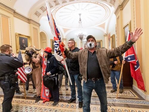 Rioters supporting President Donald Trump's claims of election fraud confront U.S. Capitol Police officers outside the Senate Chamber after breaking into the Capitol building on Jan. 6, 2021. (Manuel Balce Ceneta/AP)
