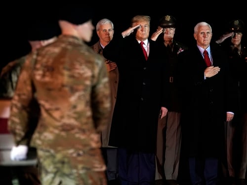 President Donald Trump and Vice President Mike Pence watch as a U.S. Army carry team moves a transfer case containing the remains of Sgt. 1st Class Javier Gutierrez, of San Antonio, Texas, Monday, Feb. 10, 2020, at Dover Air Force Base, Del. (Evan Vucci/AP)