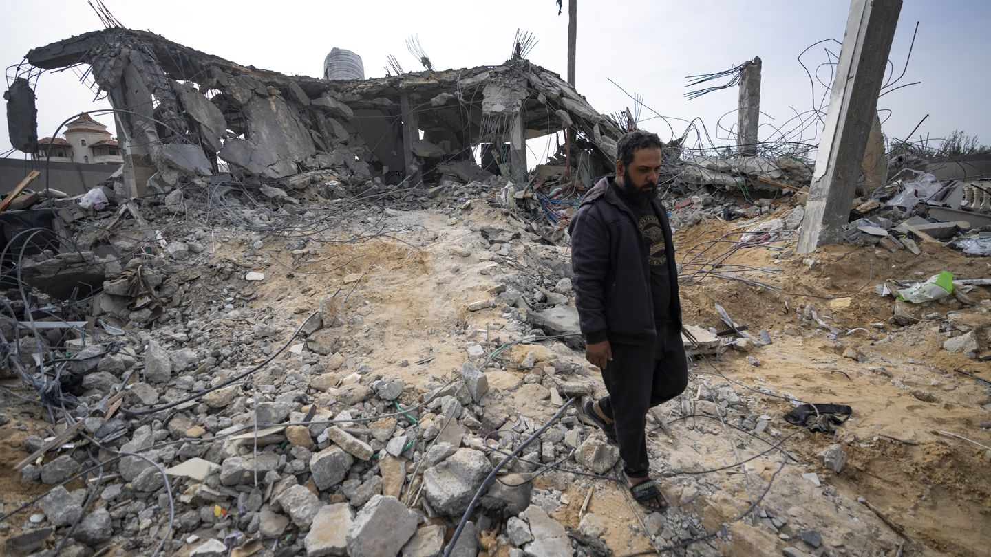Palestinians look at a house destroyed in an Israeli strike in Rafah, Gaza Strip, on March 26, 2024. (Fatima Shbair/AP)