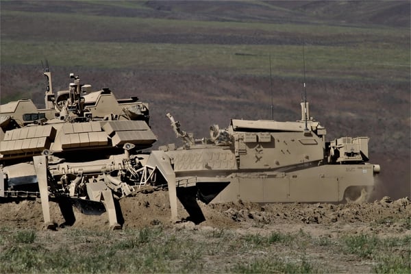 Two assault breacher vehicles were used in the demonstration. One cleared mines, creating a path for the second ABV with the capability to fill in tank trenches. (Jen Judson/Staff)