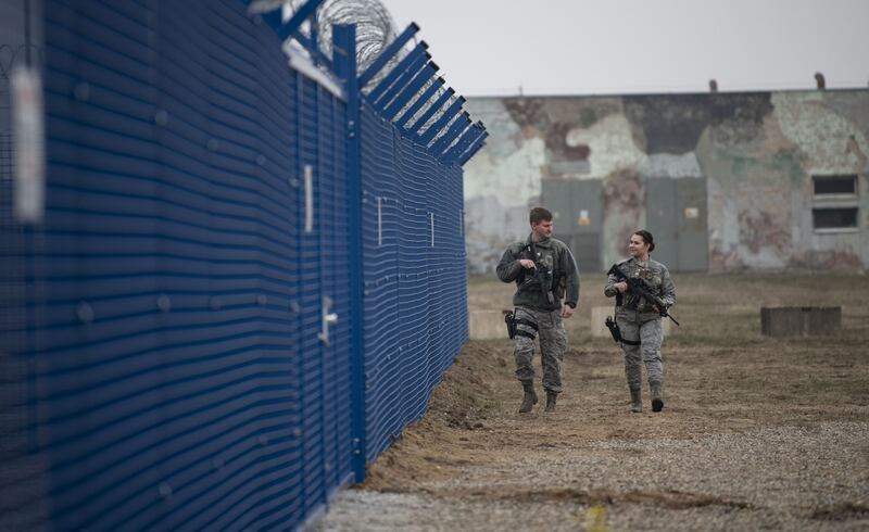 U.S. Air Force security forces with Detachment 2 patrol the fence line of a secured processing center at Miroslawiec Air Base, Poland, Feb. 28. (Senior Airman Preston Cherry/Air Force)