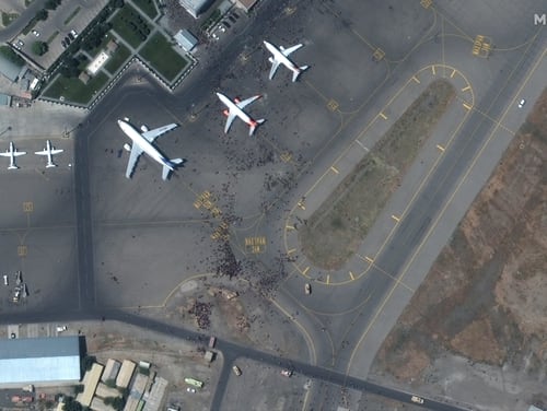 Satellite imagery shows crowds of people gathered on the tarmac at Hamid Karzai International Airport in Afghanistan as thousands of people try to exit the country. (Maxar Technologies)